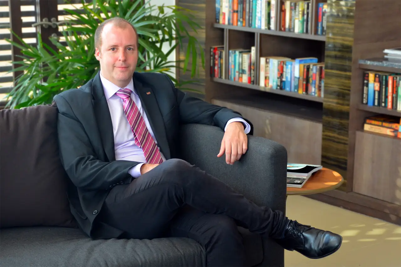Koen Vermeersch | Area Manager, Ascott Thonglor Bangkok sitting on sofa in an office