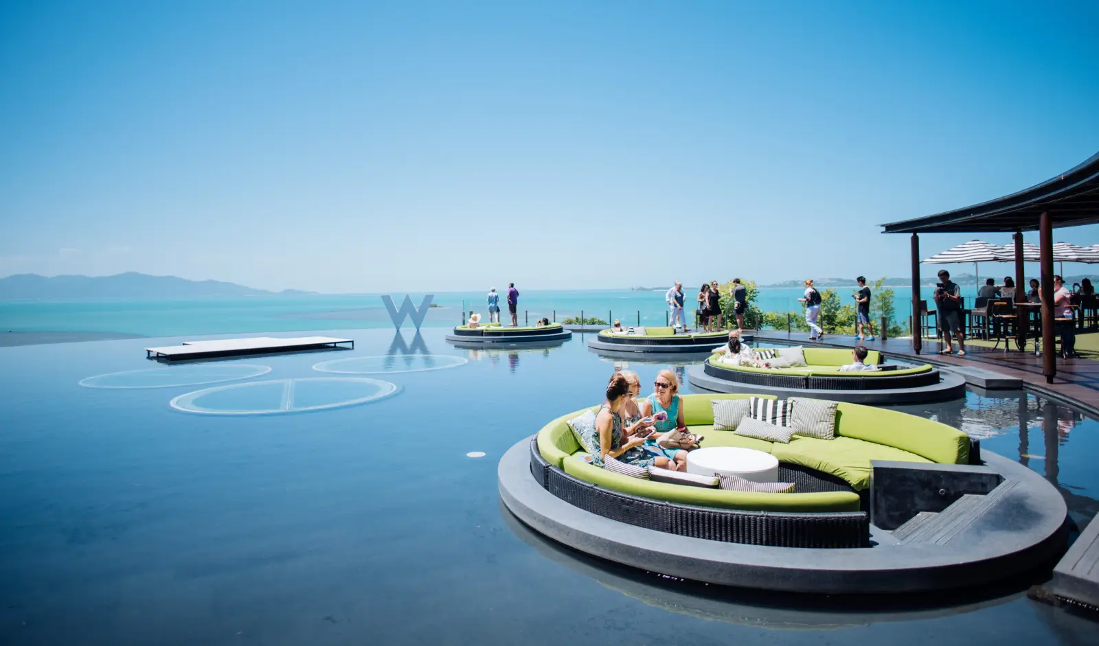 people sitting on a pool in a luxury hotel in Phuket